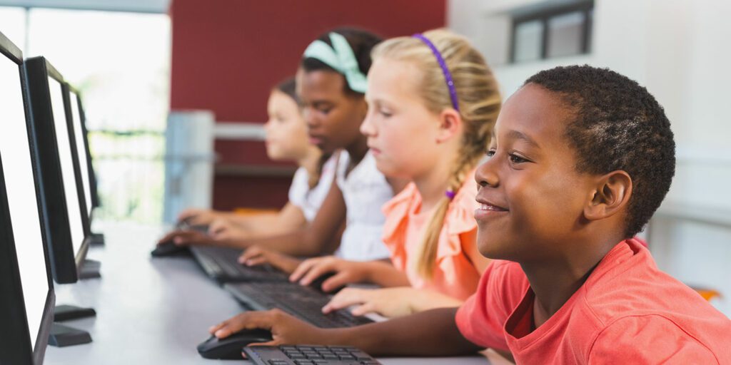 Students working on computers in a classroom.