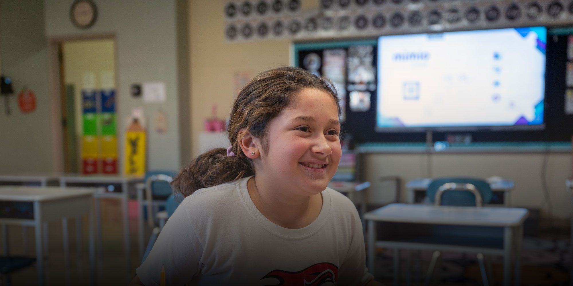 Smiling student working in classroom